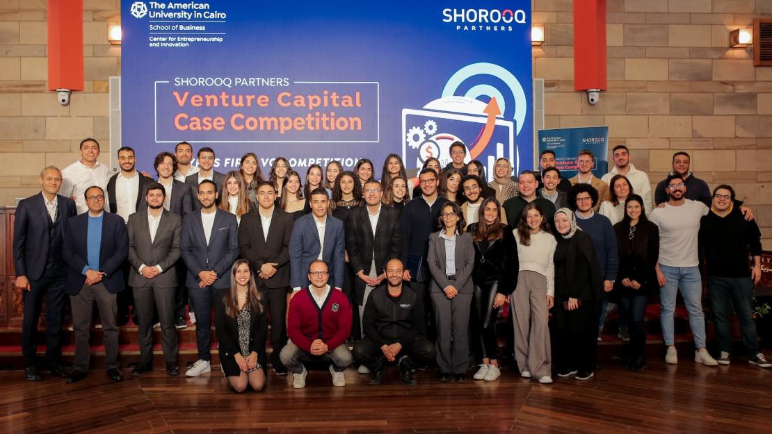 people stand on stage at the Venture Capital Competition