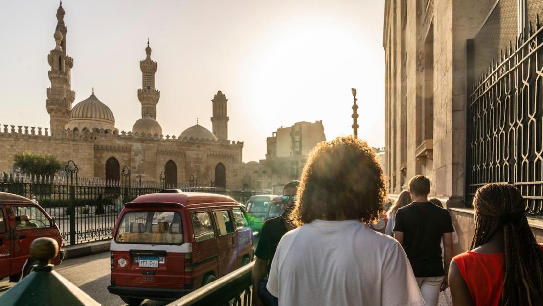 A photo of a Cairo street, taken from Abdelhalim. Al Azhar mosque sits to the left and the wall of Khan al Kalili is on the right. 