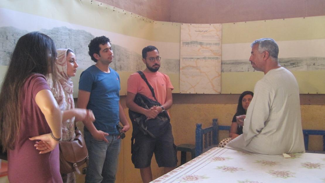 Abdu Daramalli speaks to students with the Living Villages exhibition around them which had been put up just for that day.