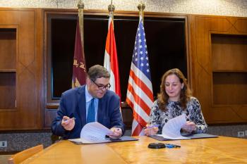 AUC Counselor Ashraf Hatem and NMI Executive Director Sherifa Fouad Sherif sign the memorandum of understanding