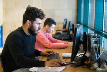 AUC students on the computers in the library 
