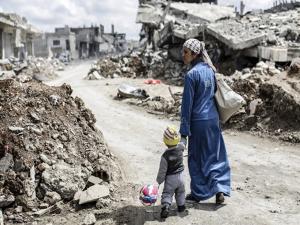 a woman and her child in a warzone