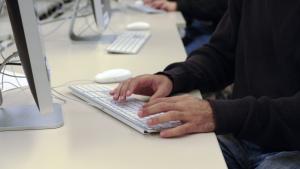 a person typing on computer keyboard