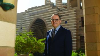 AUC President Ahmad Dallal standing in front of Portal