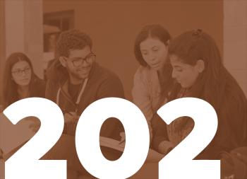 girls and boys together looking at a book. 202 written in white on the picture