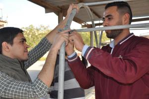 students adjusting pipes for water and irrigation
