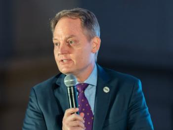 a man talking into a microphone