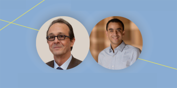 Two men smiling with light blue background