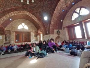 A group of girls and boys sitting in a mosque