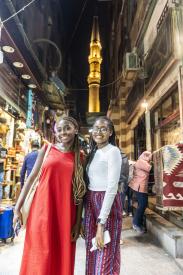 Two girls in Cairo old street smiling
