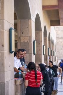 A group of girls and boys on campus talking