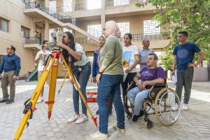 group of students with architecture and construction equipment working together on campus 