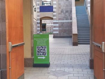 a green sign at a door