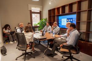 a group of men sitting in a meeting room