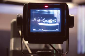 A camera positioned on a tripod prepared for a shooting