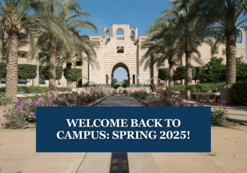A building in garden with palm trees on the sides