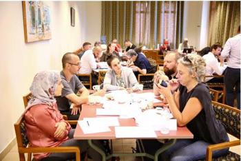 a group of faculty and students sitting together in a classroom