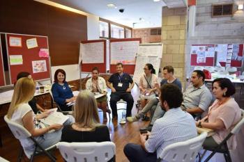 a group of faculty and students sitting together in a classroom