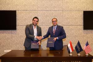 Two men shaking hands after signing agreement