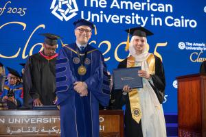 Female graduating senior with the President of the University