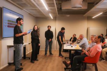 a group of students giving a presentation inside one of the innovation hub meeting rooms