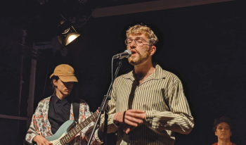 Alexsander singing with guitarist in back