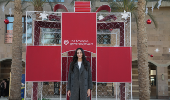 Monica Magdy stands in front of a wire gift box