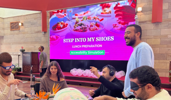 Students participating in the simulation with "stepping into the shoes of others" on the board