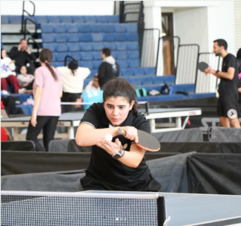 A female athlete is playing table tennis