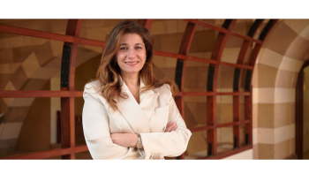 Farah Kashlan stands with her arms crossed in a hallway