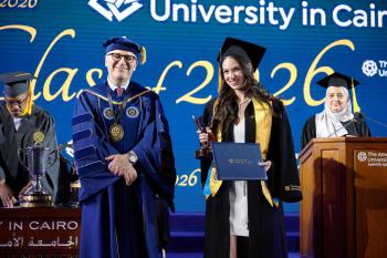 Student Jana Khairy with AUC President receiving an award in commencement  