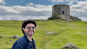 A man standing near a monument 