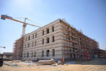 A large building under construction-- part of the campus development project