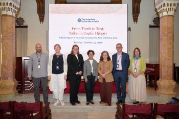 Speakers of the conference standing in front of the backdrop of the conference in Oriental Hall