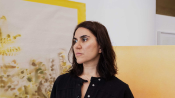 Woman in black long sleeve, yellow background.