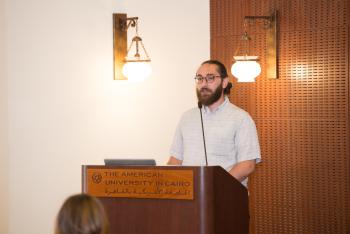 AUC alum Rasheed Idou speaks to the LAWAC delegation. 