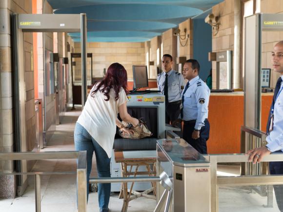 Two AUC security personnel performing a security check. 