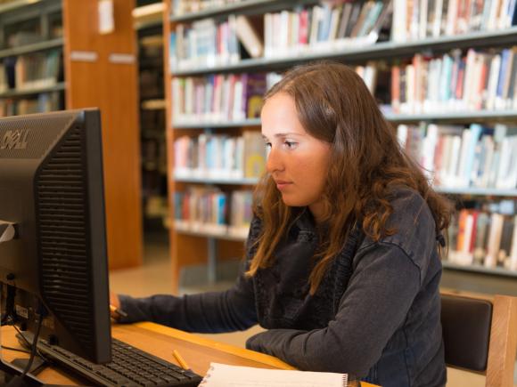 student in library