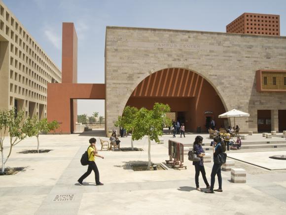 Students walking around the campus plaza