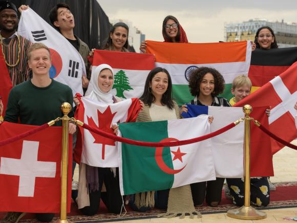 Group of students holding their countries flags