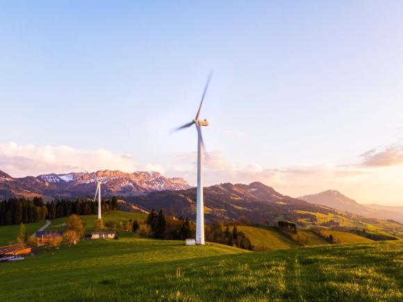 Windmills, mountains, trees, houses, greenery to represent energy transition for climate change