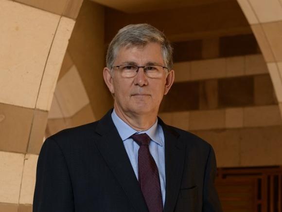 A man standing and wearing a suit