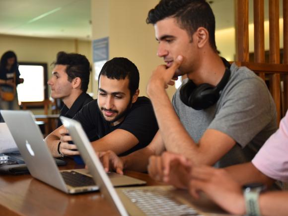 Boys sitting on laptop