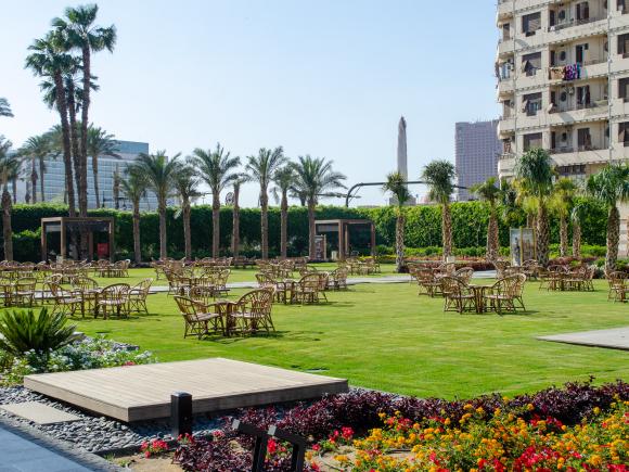 A garden with chairs and tables