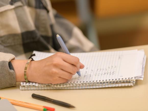 Student writing in Arabic