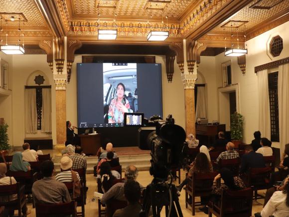 Group of people in a hall watching projector