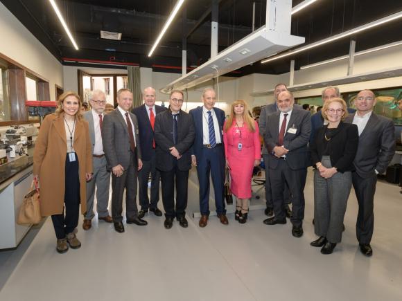 The Board of Trustees, faculty and staff visit Eltoukhy Learning Factory, pose in a line in front of lab equipment