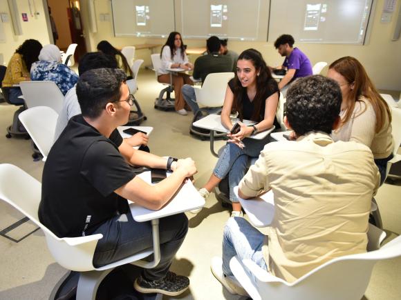 students working in a group in classroom having a group discussion