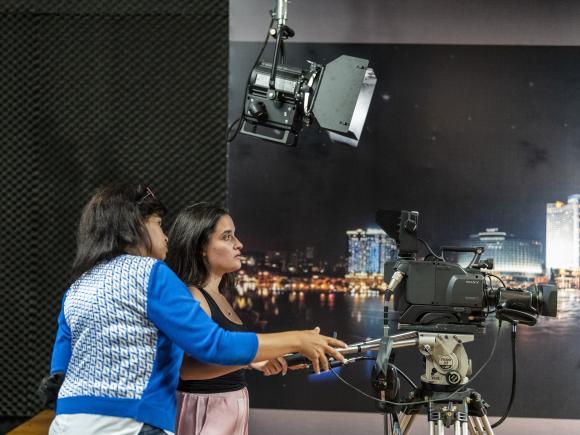 students working with cameras in studio filming