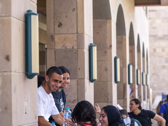 A group of girls and boys on campus talking